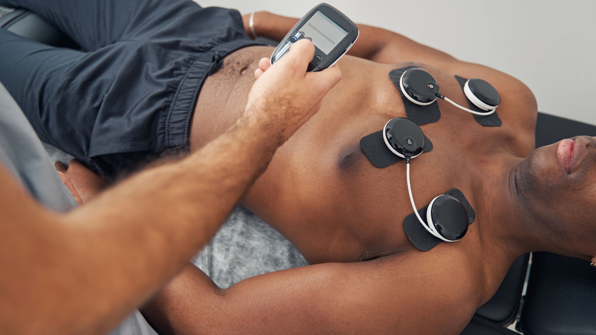 A man laying on a couch holding a cell phone