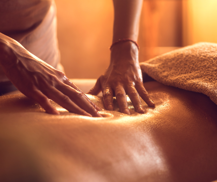 A woman getting a back massage at a spa in astoria ny